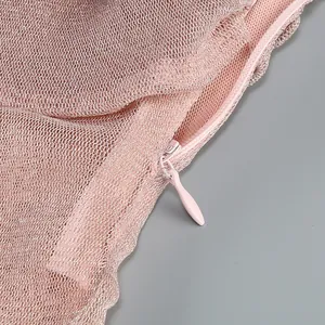 Close-up of the concealed zipper and pink sheer mesh fabric on this sexy evening dress