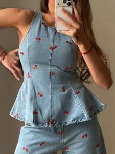 Vintage light blue denim set with red cherry embroidery, peplum top and matching pants.