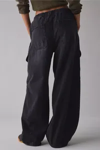 Back view of women's loose charcoal grey denim cargo pants with elastic waist