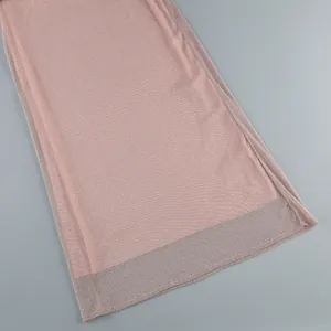 Close-up of pink shimmering fabric hem with sheer metallic finish