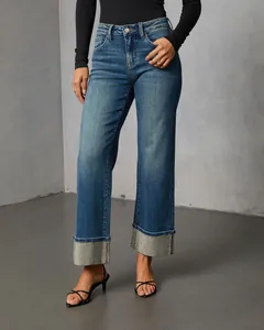 Detailed studio view of women's straight-leg blue jeans with sparkling rhinestone cuffs