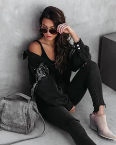 Chic black denim jacket with silver chain and stud details for a street fashion look