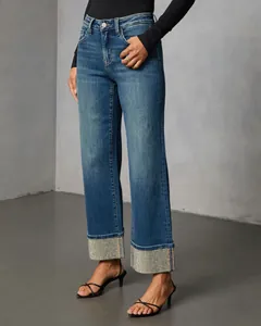 Detail view of stylish straight-leg jeans featuring sparkling rhinestone-encrusted cuffs.