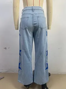 Back view of light blue straight jeans with blue star patches and white pearl beads