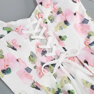 Close-up of pink rose floral print dress featuring white lace-up corset detail
