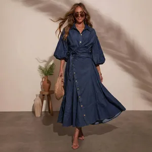 Detailed view of a casual denim dress with lantern sleeves and a belted waistline.