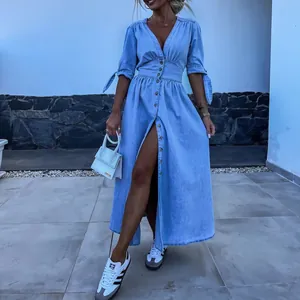 Detailed view of light blue V-neck long denim dress with button-down front.