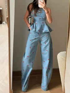 Retro denim two-piece set featuring red cherry embroidery, peplum top, and wide-leg pants.