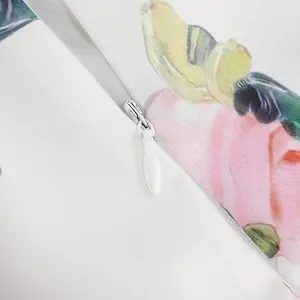 Close-up of the smooth hidden zipper on this floral print midi dress for women.