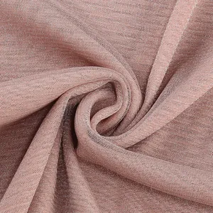 Macro view of metallic rose gold ribbed knit fabric texture for an elegant formal long dress
