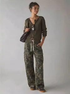Full view of model styling loose camouflage cargo pants with functional side pockets