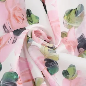 Close-up of floral print fabric showing soft texture and vibrant watercolor patterns.