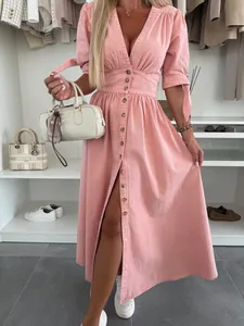 Fashionable pink V-neck button-down denim maxi dress shown in a lifestyle closet setting