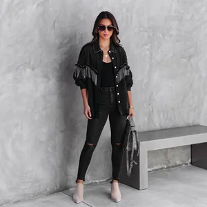 Black street fashion denim jacket with fringe and rivet details on fashion model