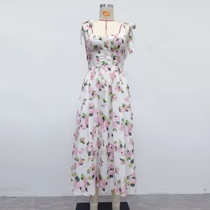 Detail of white floral print midi dress featuring adjustable shoulder tie straps