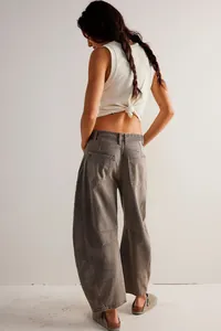 Back view of women's relaxed barrel leg jeans featuring unique paneling in washed grey denim