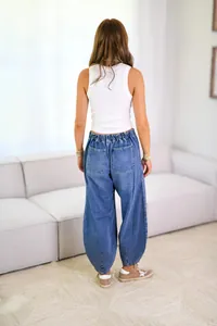 Back view of casual women's baggy denim pants featuring elastic waist and large back pockets
