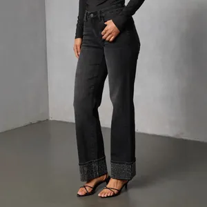 High-waist black washed straight jeans with sparkling rhinestone-studded folded cuffs.
