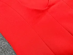 Vue détaillée de la texture du tissu rouge vif de haute qualité d'une robe blazer pour femmes