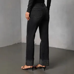 Stylish black straight leg jeans for women featuring sparkling rhinestone wide cuffs.