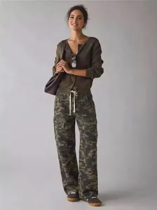 Full body view of casual women's camouflage cargo pants and dark olive knit cardigan