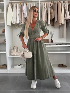 Chic olive green V-neck denim maxi dress featuring button front and adjustable tie sleeves