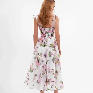 Elegant floral midi dress with tie-shoulder straps and corset back on white background.