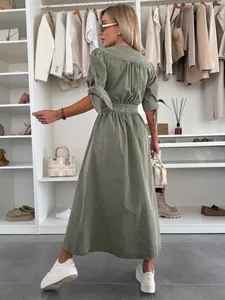 Detail view showing the back of a sage green V-neck denim maxi dress with ties