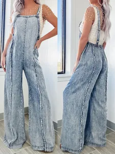 Vintage acid wash denim overalls with frayed seams and stylish wide leg cut.