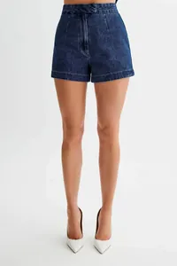Detail view of high-waisted dark blue denim shorts with professional seam tailoring.