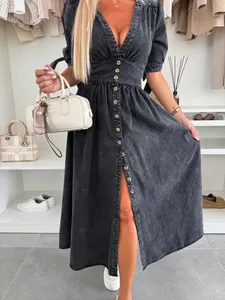Close-up detail of a stylish black V-neck denim maxi dress with front buttons and slit