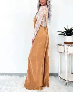 Macro view showing the frayed edge detail and corduroy texture of vintage wide-leg overalls