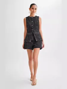 Model showcasing a chic black denim sleeveless top and high-waisted shorts set for summer
