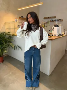 Casual wide-leg blue jeans featuring decorative dark star patches with rhinestone outlines.