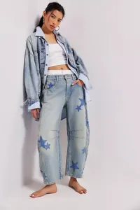 Detail of relaxed baggy barrel leg jeans with blue star print patterns