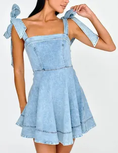 Light blue denim mini dress with elegant ribbon tie shoulder straps for summer.