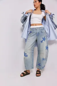 Detail view of baggy barrel jeans featuring dark blue star prints and comfortable mid-waist fit.