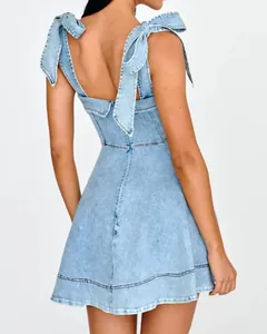 Rear view of a light blue denim mini dress featuring elegant tie-shoulder straps detail