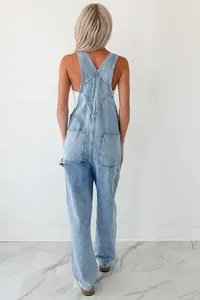 Back view of stylish light blue wash denim overalls with cross-back straps and pockets