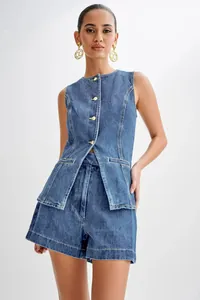 Full view of women's denim vest and high waist shorts set with gold accessories