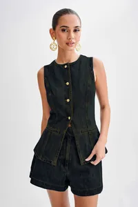 Detailed view of a dark denim sleeveless vest and high-waisted shorts set on a model