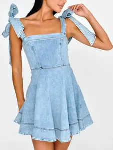 Fashionable light blue denim mini dress with tie-shoulder bow straps and A-line skirt.