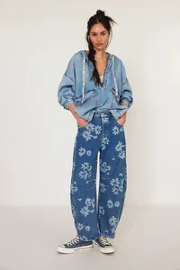 Women's casual loose mid-waist barrel jeans with stylish floral daisy print design.