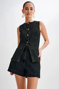 Close-up of women's sleeveless denim vest and high-waisted shorts set in dark indigo finish