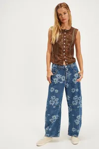 Professional full-length view of women's relaxed floral print wide-leg jeans on model