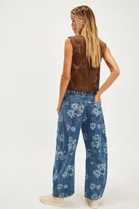 Full rear view of women's casual loose barrel jeans with light blue floral print patterns