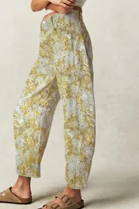 Model wearing vintage floral print loose barrel jeans for women in soft yellow tones