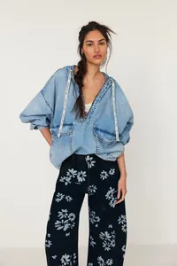 Loose mid-waist barrel jeans with light blue floral print on dark denim