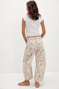 Back view of women's loose casual barrel jeans featuring a vintage faded cat print