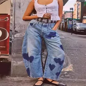 Casual women's loose wide-leg light blue denim jeans featuring dark heart patterns